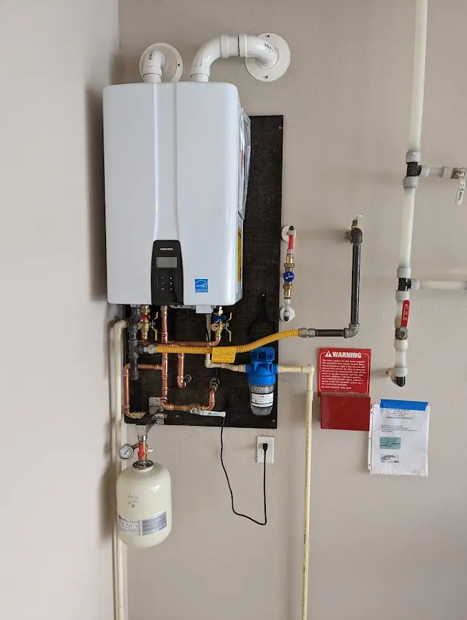 Professional plumber installing copper piping in a Highland Falls home